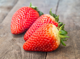 Close up of big strawberry on wood 