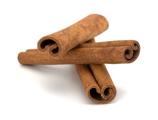 cinnamon sticks stacked on white background