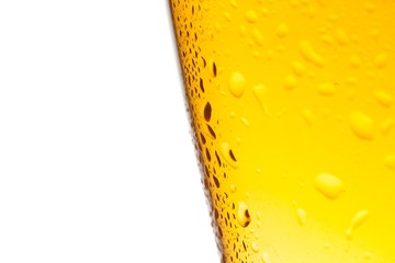 detail of glass of fresh beer with drops on white background