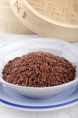 uncooked red rice in a bowl