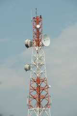 Communication tower with antennas against the blue sky
