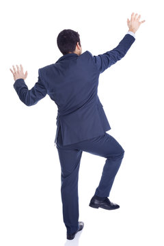 Handsome Businessman Climbing A Wall, Isolated On White