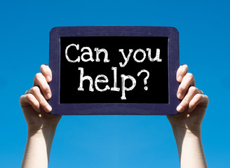 Can you help ? Woman holding blackboard over blue background