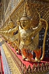 golden statues on the wall of the Grand Palace