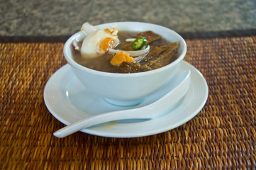 asian style boiled rice in round white bowl on  wood table