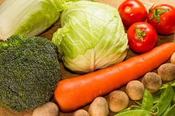 Variety of fresh vegetables on wooden table