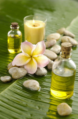 Obraz na płótnie Canvas Health spa with massage oil and frangipani,candle on green leaf