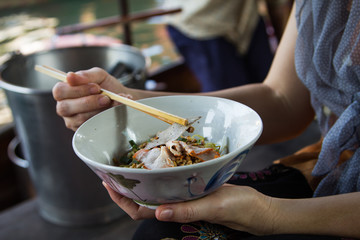 Woman eating noodles
