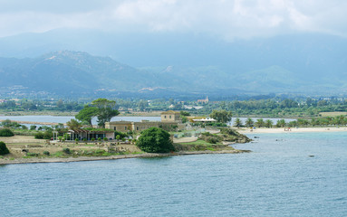 Tropical beach with people around the hotel.