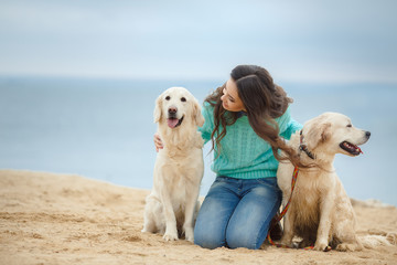 portrait of Beautiful woman with her dog on the beach near sea