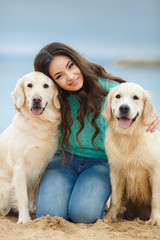 portrait of Beautiful woman with her dog on the beach near sea