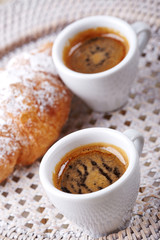 Cup of coffee with croissant 
