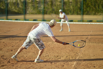 Senior couple playing tennis