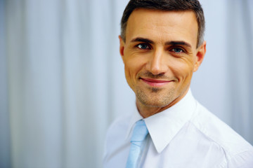 Portrait of a happy handsome businessman in white shirt