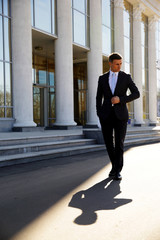 Confident businessman walking on the street