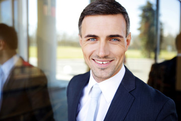 Fototapeta premium Portrait of a happy handsome businessman in suit