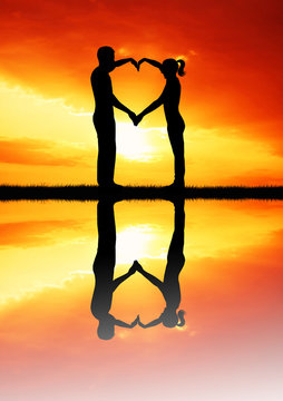 couple and heart at sunset