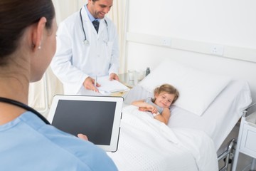 Doctors attending sick girl
