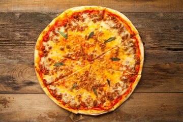 Bolognese pizza on wooden table.