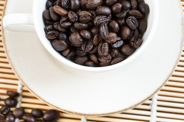 A cup and coffee beans, from above