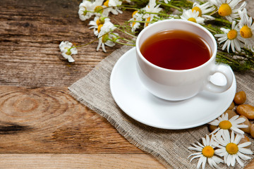 herbal tea with chamomile on old wooden table