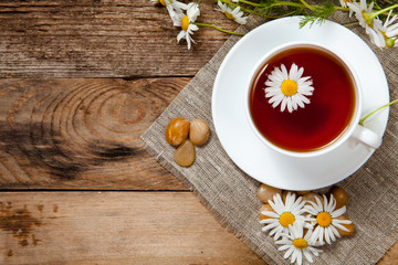 herbal tea with chamomile on old wooden table