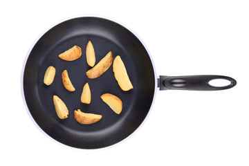 Fried potatoes on a black frying pan.