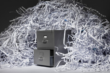A file cabinet and lots of shredded paper.
