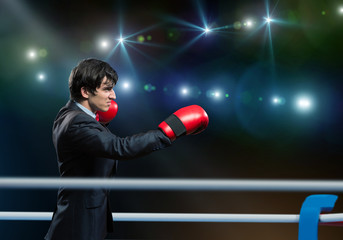 businessman with boxing gloves in the ring