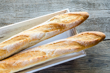 Two baguettes on the wooden tray