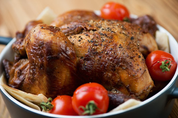 Baked chicken with tomatoes on pita bread, close-up, studio shot