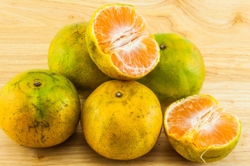 Tangerine on wood background