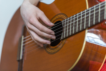 Fototapeta premium Female hands playing guitar