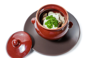 Meat dumplings and mushrooms with sour cream and herbs