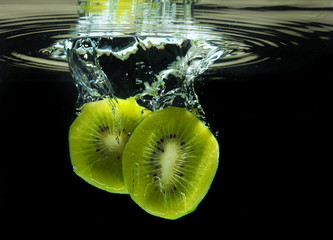 Delicious sliced kiwi dropped in water