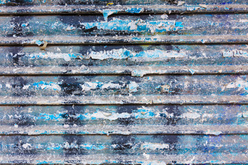 Grunge rusty iron door texture with stripes and old papers