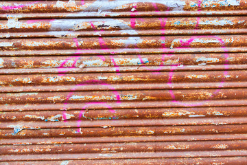 Grunge rusty iron door texture with stripes and old papers