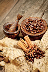 Cinnamon, star anise and coffee beans on old wooden table