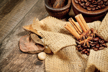 Cinnamon, star anise and coffee beans on old wooden table