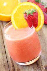 Freshly made orange and strawberry smoothie