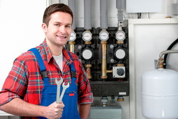 Technician servicing heating boiler