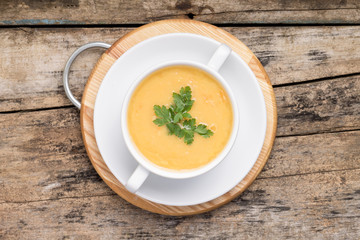 Pea soup in White Bowl on grunge wood background. Top View