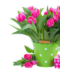 bunch of pink tulips in green pot