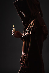 wizard in black cape with candle