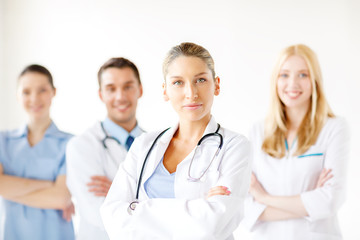 Fototapeta premium serious female doctor in front of medical group