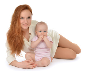 Happy family mother and child baby girl hugging lying