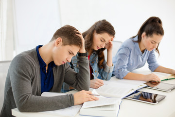 students with notebooks and tablet pc at school