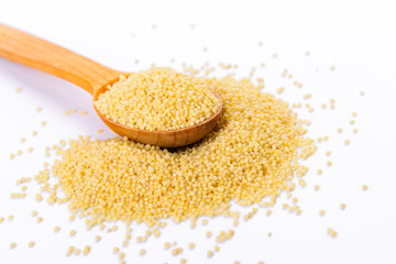 Millet in a wooden spoon