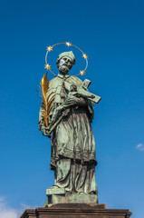 Fototapeta na wymiar The statue of John of Nepomuk on Charles Bridge (Prague, Czech R