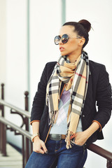 Young brunette girl closeup portrait. Stylish woman posing on th